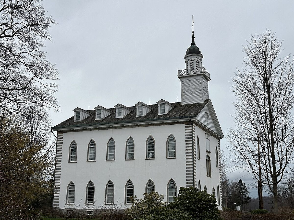 Exterior of the Kirtland Temple in Ohio, a white building with a bell tower